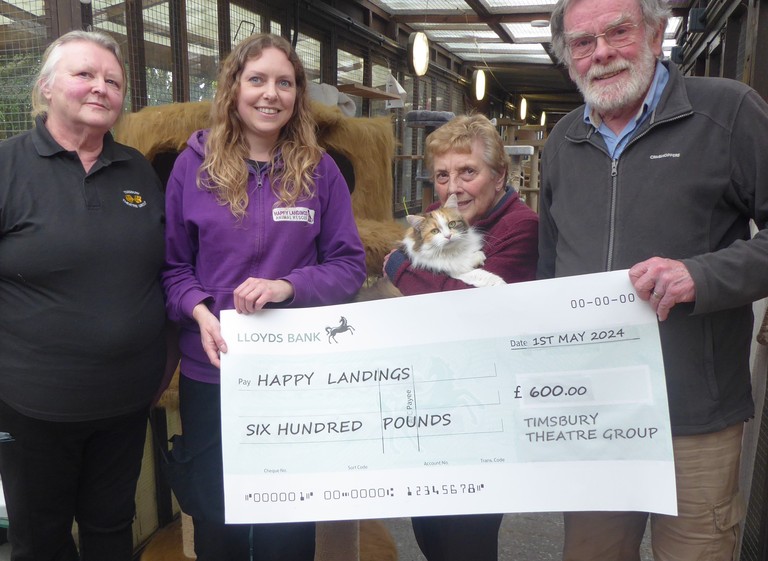 Timsbury Theatre Group representatives present Happy Landings with cheque for £600